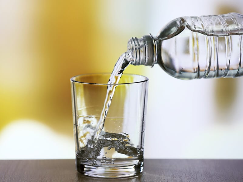 Pouring Water Bottle on Glass