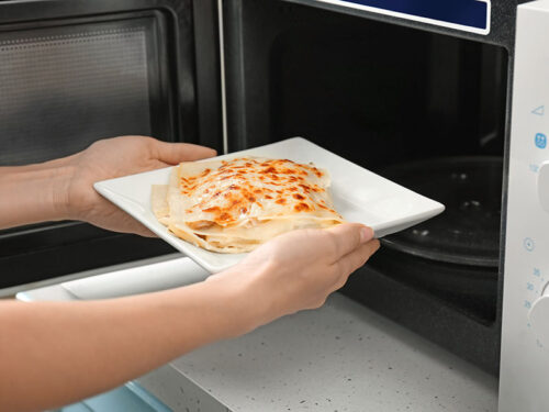 5 Methods To Reheat Lasagna Perfectly Every Time 2024   Putting Plate Of Lasagna 500x375 