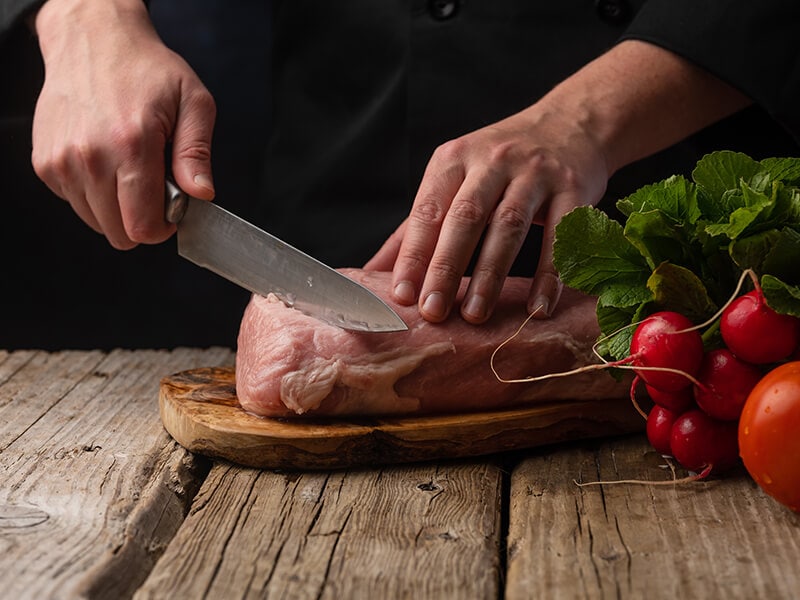 Chef Cuts Pork Meat