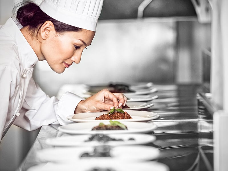 Female Chef Garnishing Food