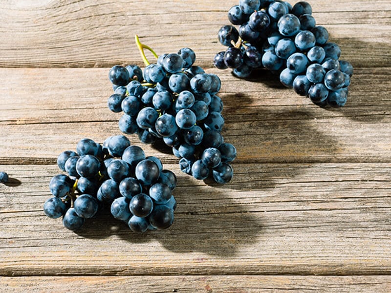 Red Grapes On Wooden Table