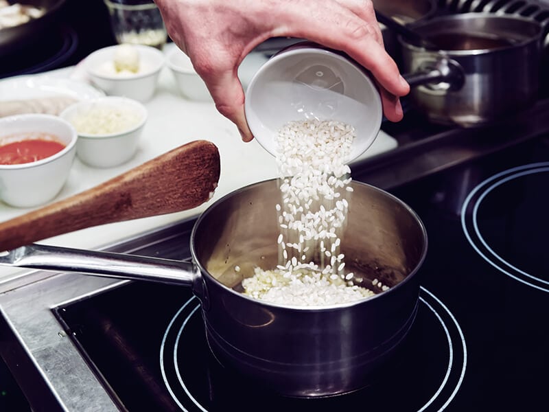 Chef Pouring Rice Stewpan