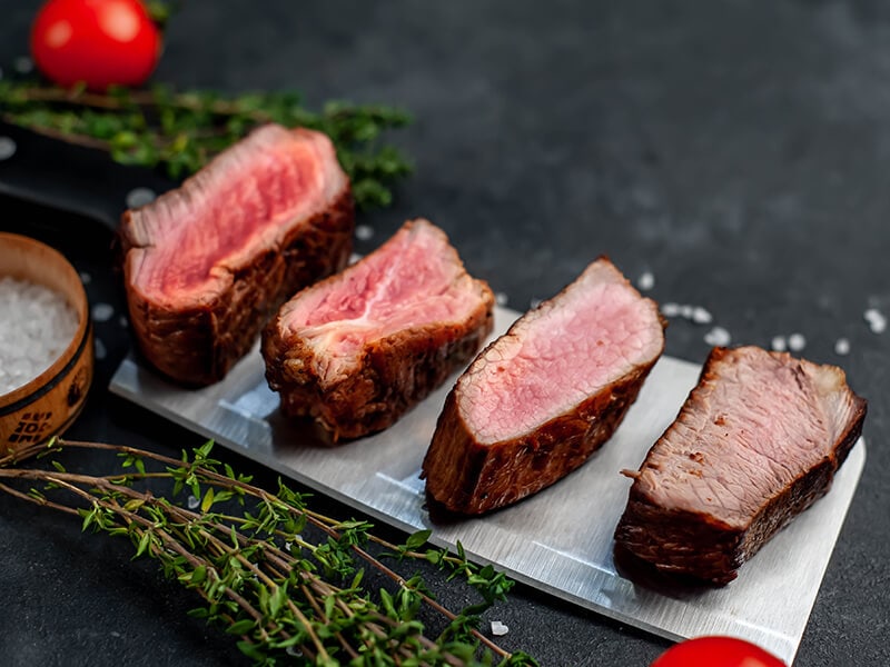 Four Steaks On Knife