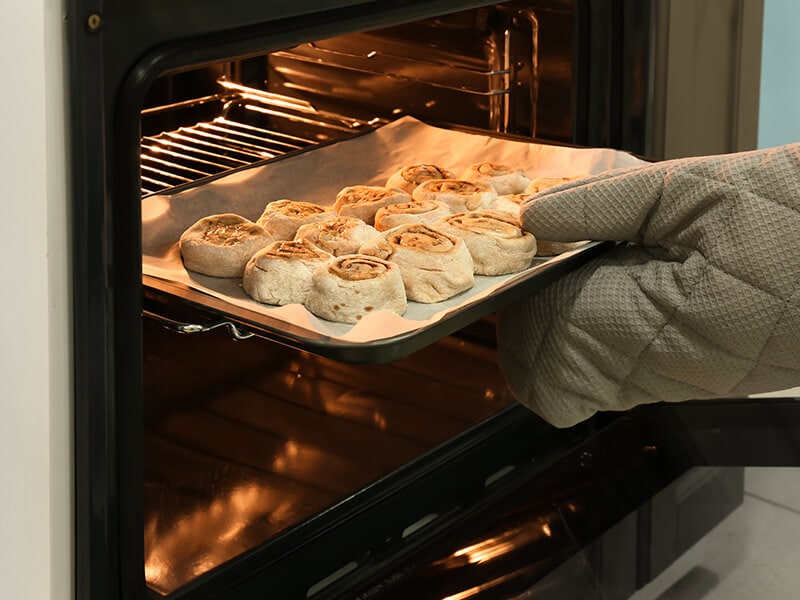 Putting Baking Tray Into Oven