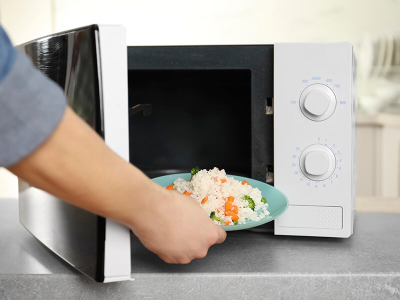 Putting Plate Rice On Microwave